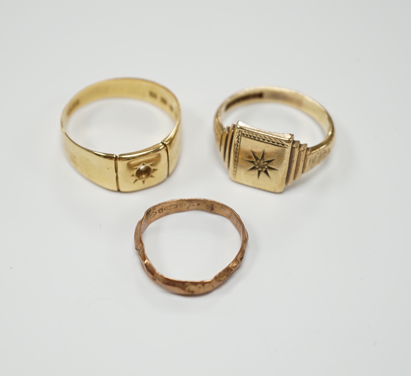 A 1930's 18ct gold signet ring (stone missing), 7.4 grams and two 9ct gold rings including diamond chip set signet ring, gross weight 6.2 grams.
